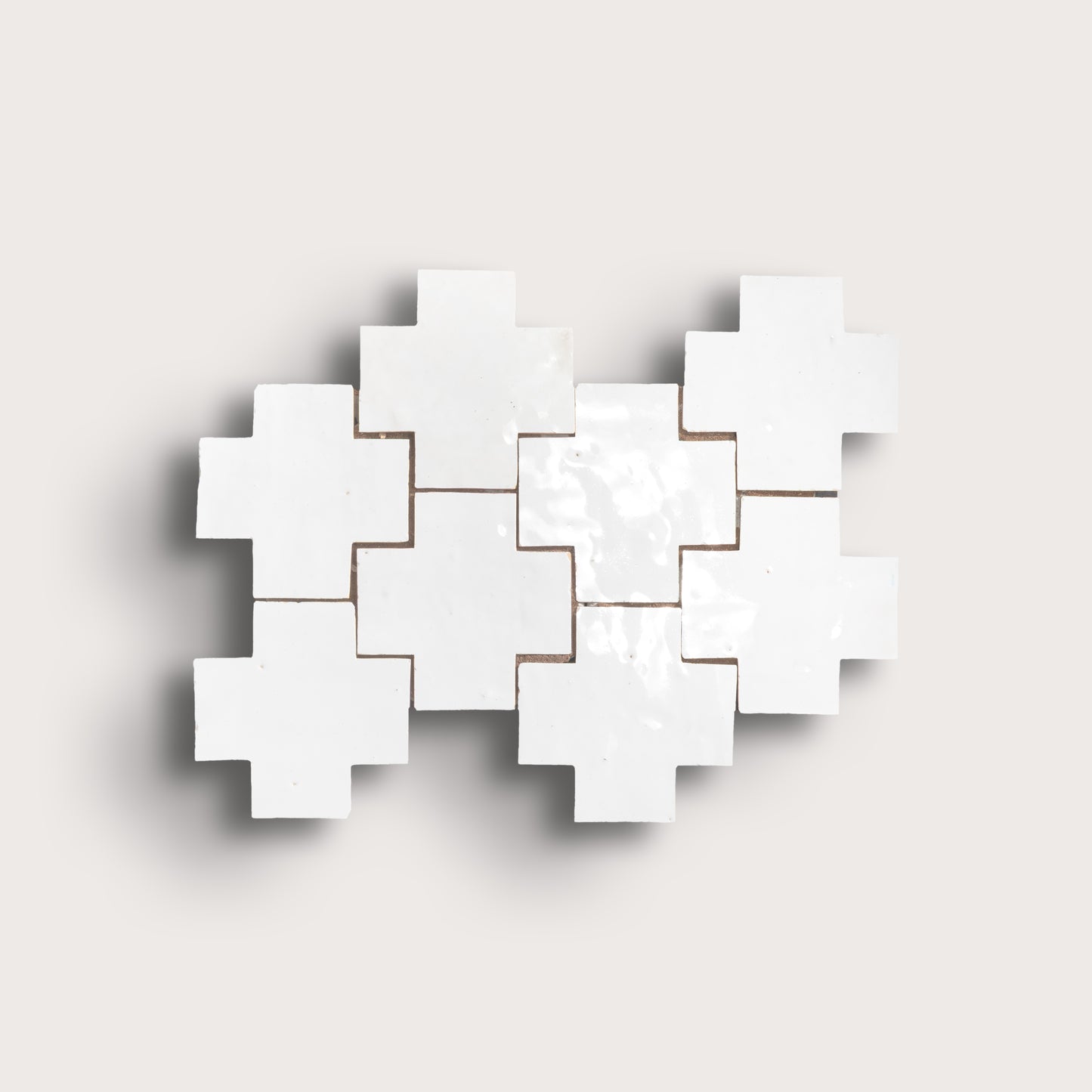 white zellige cross geometric design on a light gray background