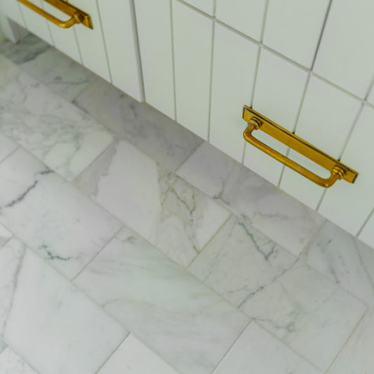 calacatta gold marble rectangle tile installed on the floor in bathroom