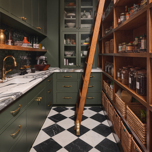 white and black marble square tile installed in a checkerboard pattern on the floor of a pantry