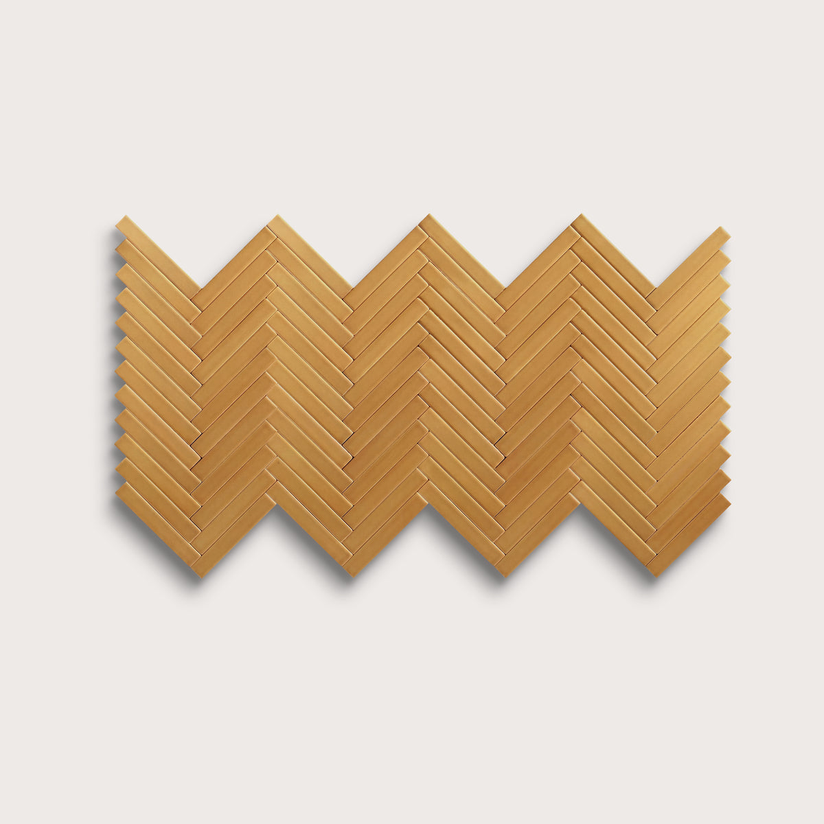 Gambol Gold ceramic tile, 1 by 6 inch herringbone mosaic, matte finish