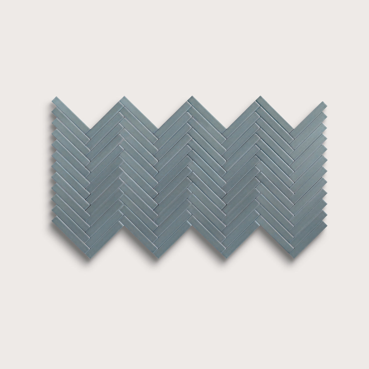 Grey Street ceramic tile, 1 by 6 inch herringbone mosaic, matte finish