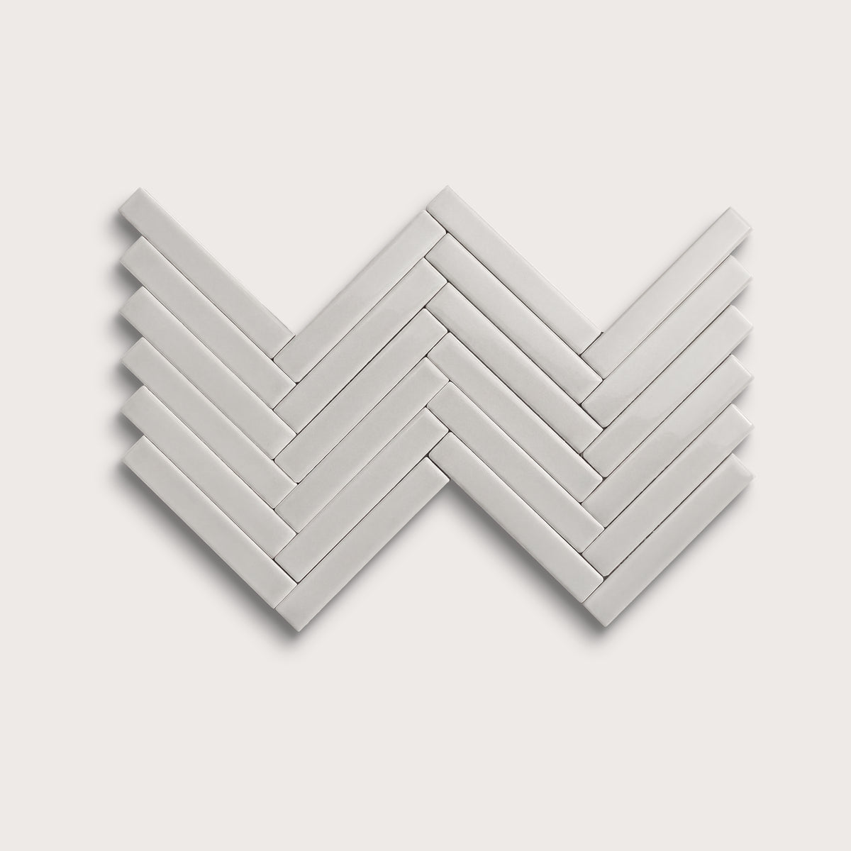 Haze ceramic tile, 1 by 6 inch herringbone mosaic, gloss finish