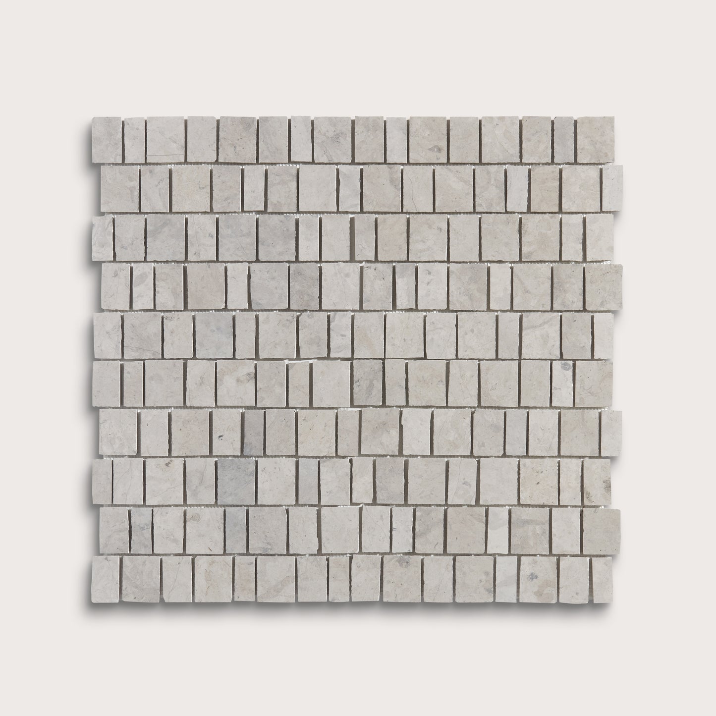 A square sample of light gray marble mosaic tiles arranged in a staggered brick pattern, shown against a solid off-white background.