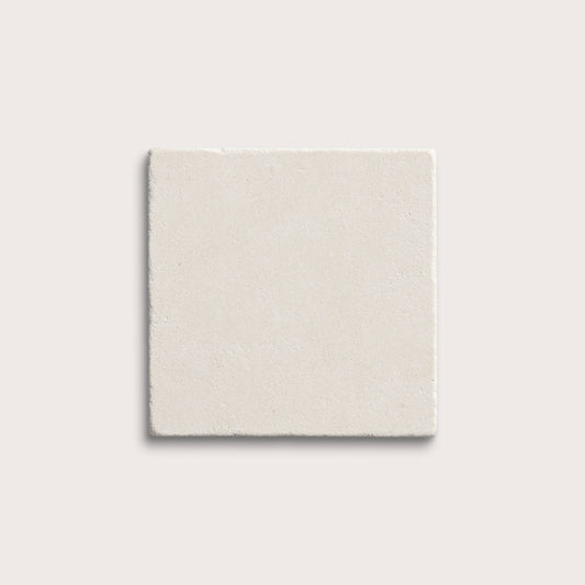 square tile with a white limestone pattern on a white background