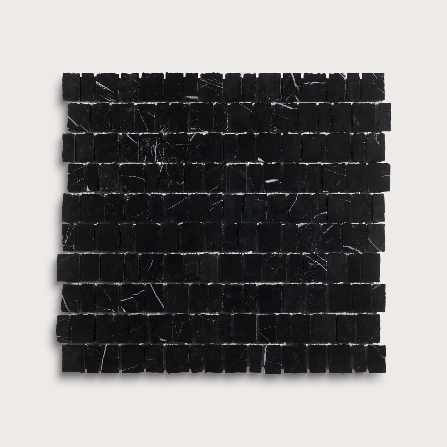 A square sample of black marble mosaic tiles with natural white veining, arranged in a grid pattern against a light gray background.