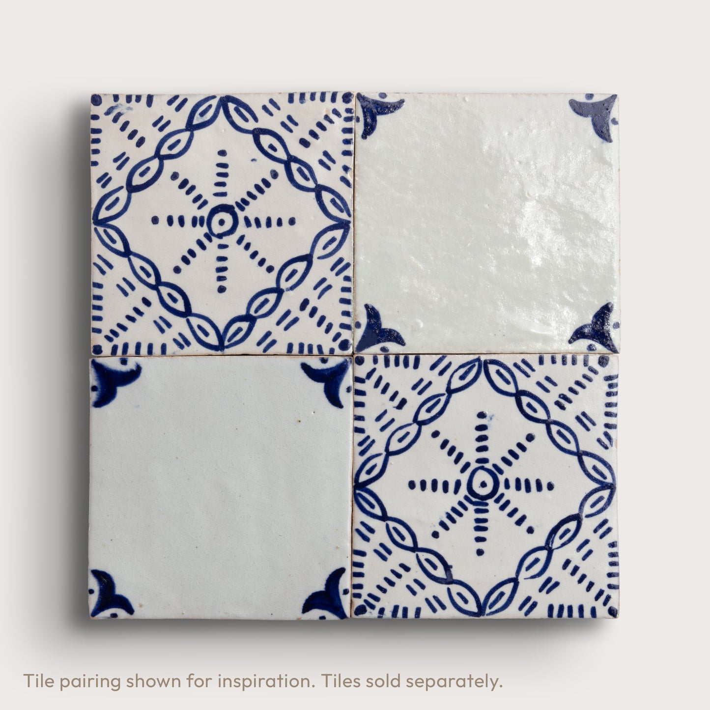 Four square zellige tiles arranged in a 2x2 grid, featuring a traditional Dutch blue-and-white pattern with one fully patterned tile and two partially patterned tiles showing the glossy glaze.