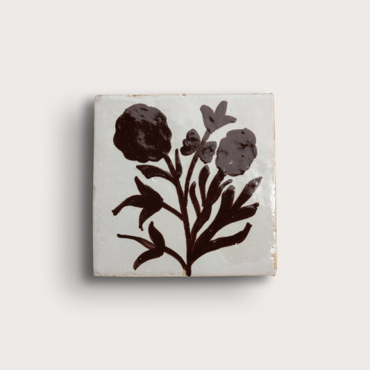 Square zellige tile, featuring a dark brown floral motif on an off-white background, with decorative corner accents.