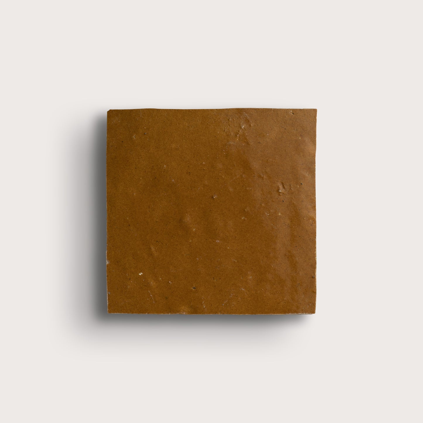 brown square zellige tile on light gray background