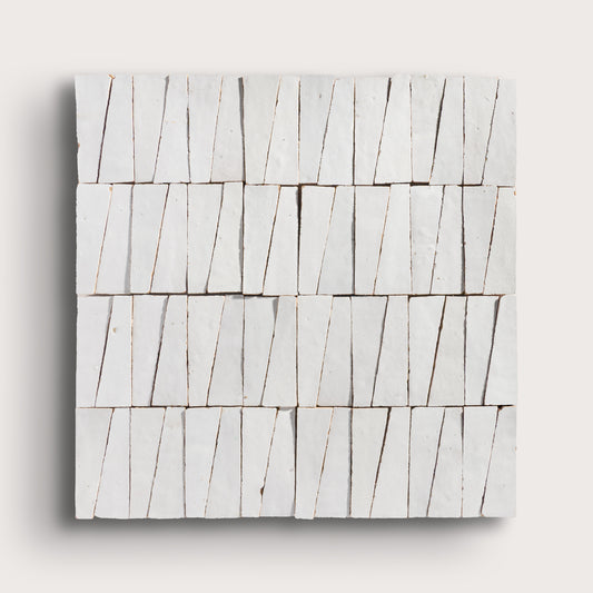 snow white trapezoid zellige tile on a light grey background