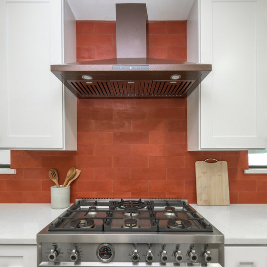 Modern kitchen with stainless steel stove and red cement tiled backsplash