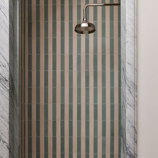 green and white cement striped pattern tile installed on shower wall