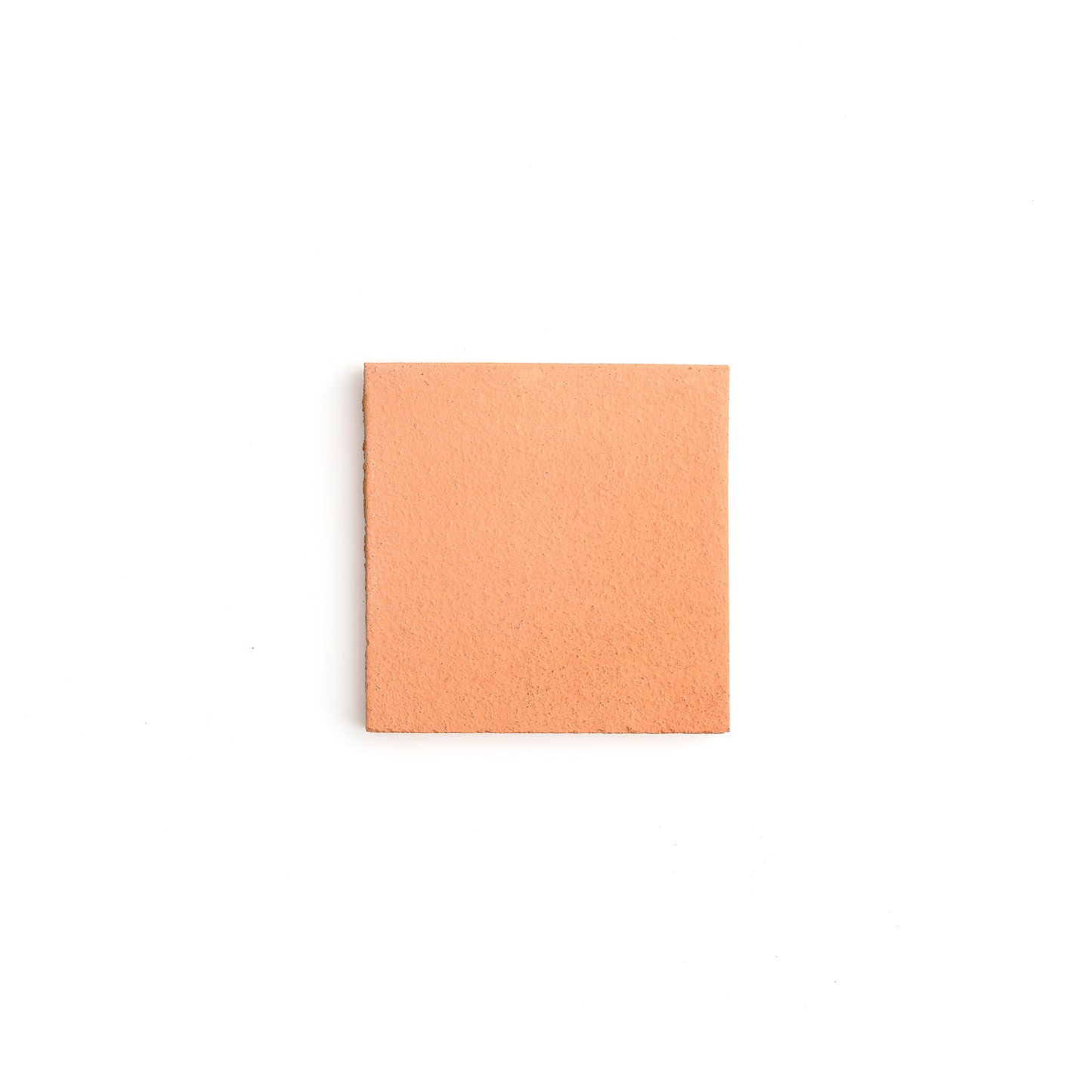 Square piece of terracotta tile on a white background