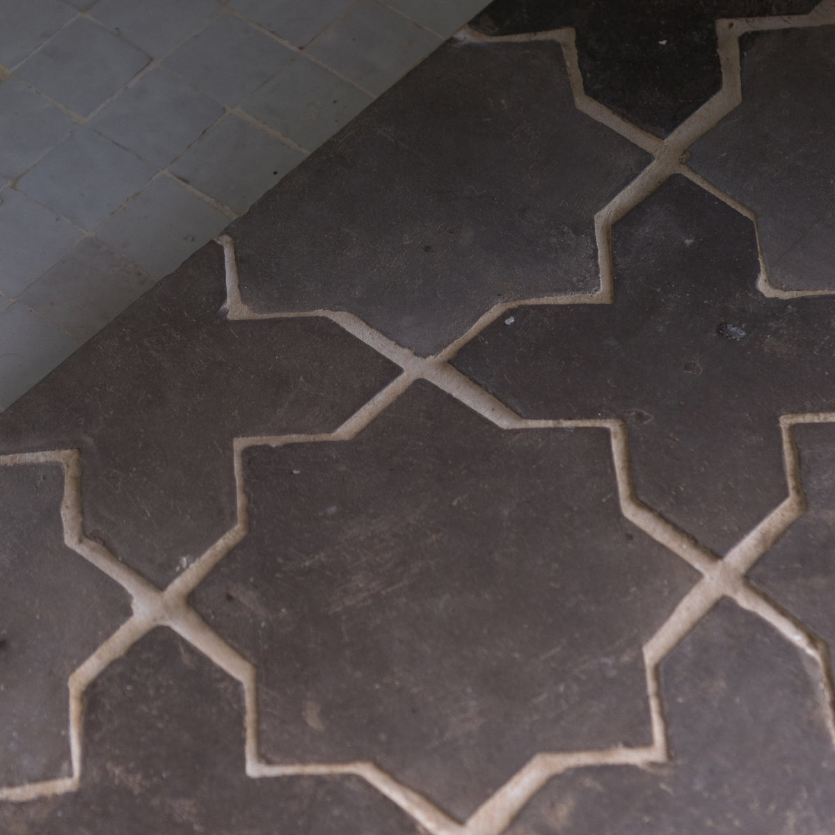 black terracotta star and cross tile on floor
