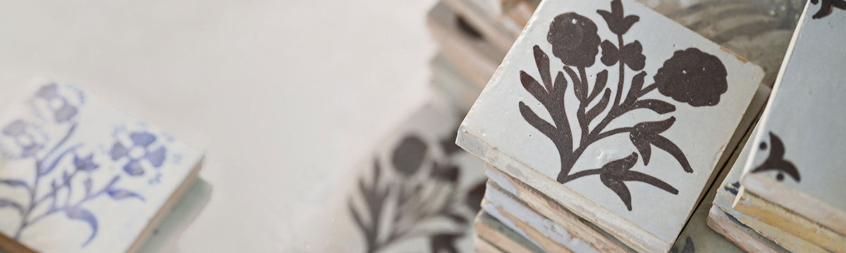 zellige tile with blue or brown hand-painted patterns