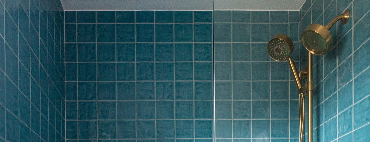 square blue ceramic tile installed in shower