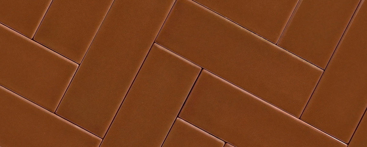 brown ceramic tile in herringbone pattern