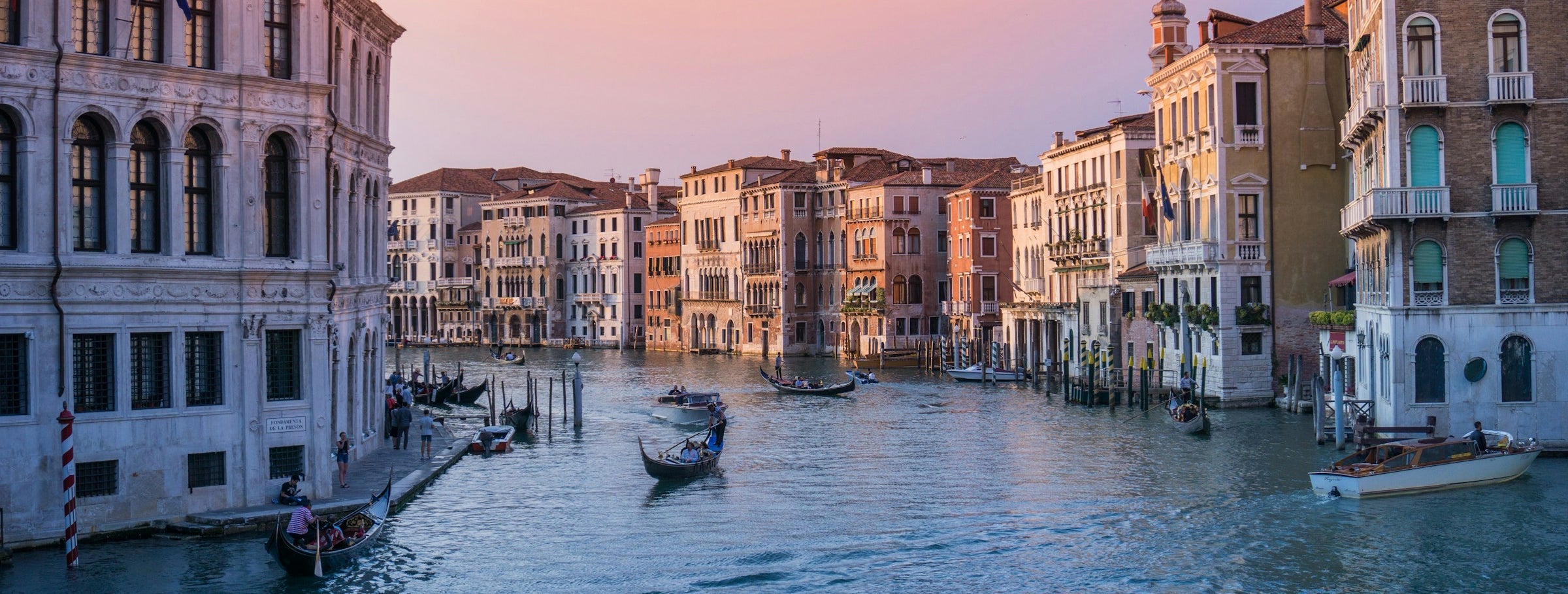 Canal in Italy with boats and houses