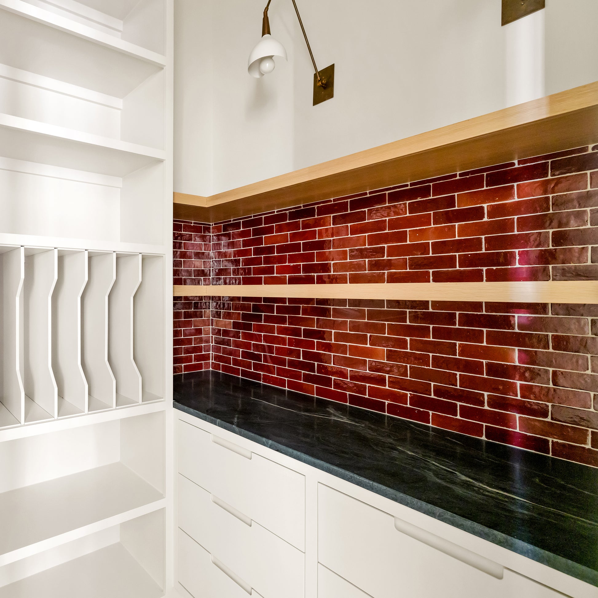 Modern kitchen with red zellige backsplash and white cabinetry