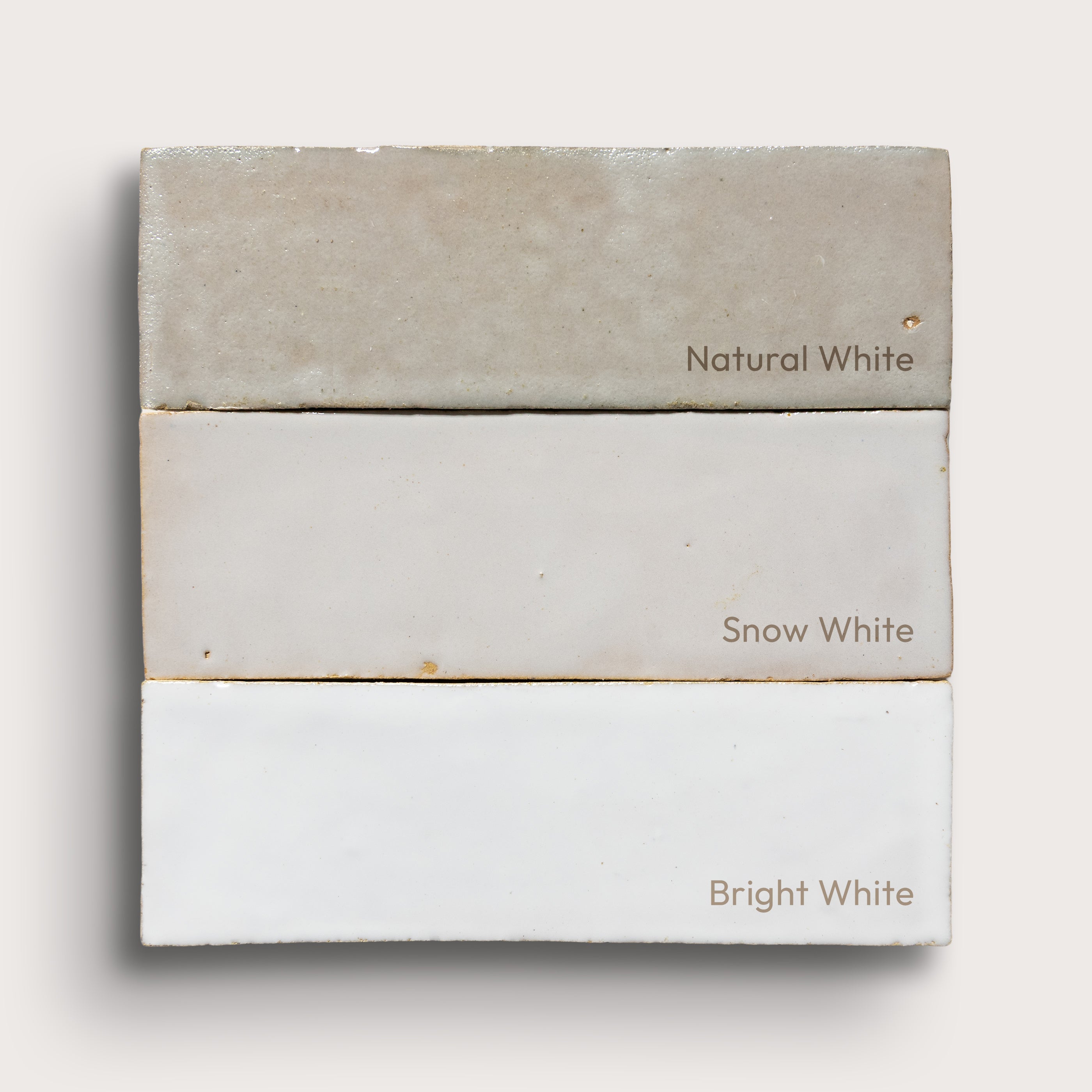 Three white zellige tiles labeled 'Natural White', 'Snow White', and 'Bright White' on a light gray background.