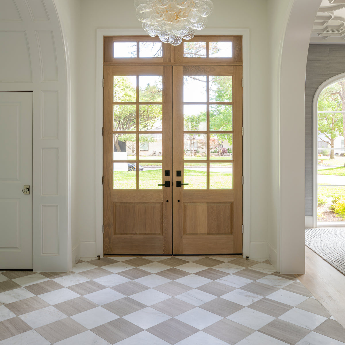 beige limestone and white marble in checkerboard pattern as flooring in entryway
