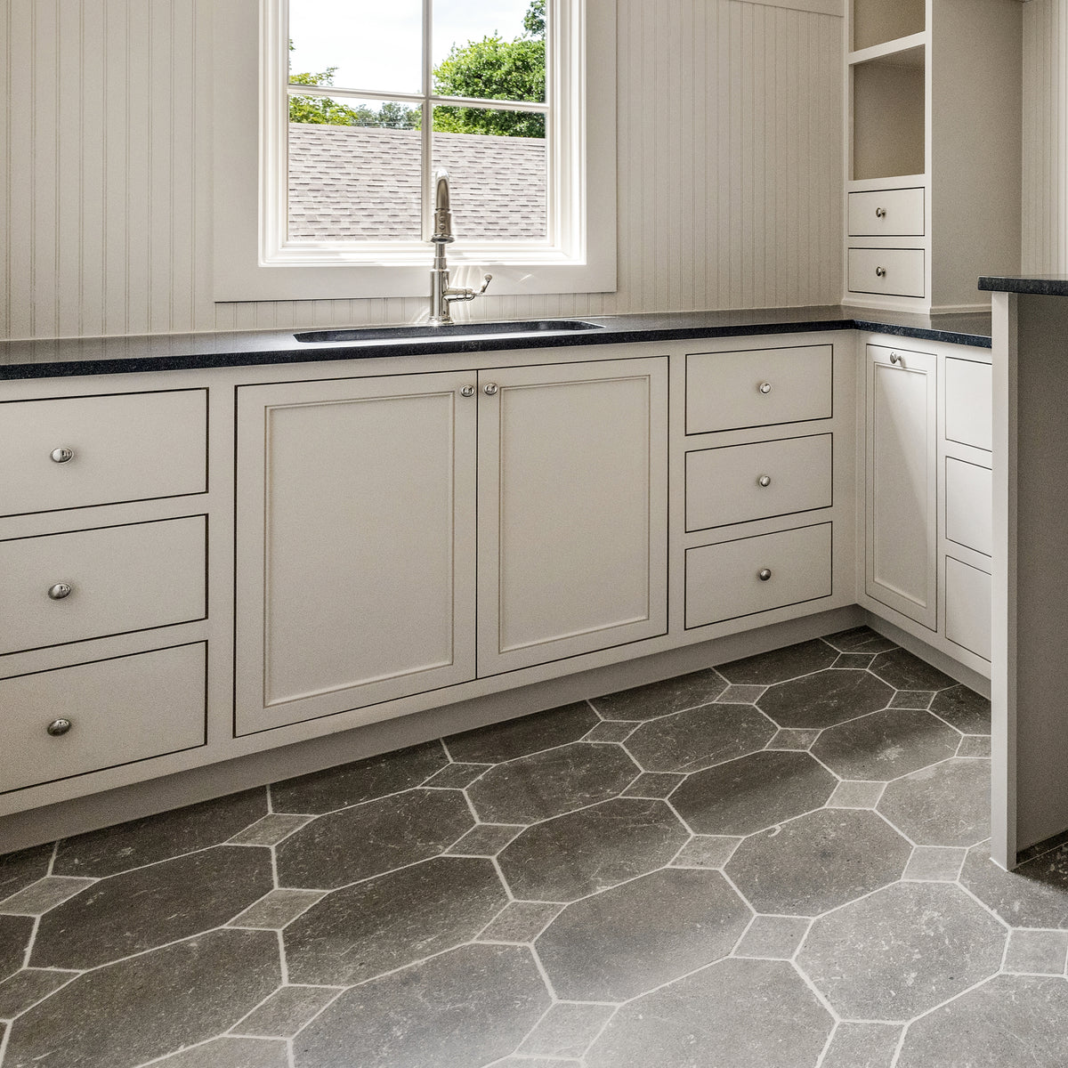 moroccan limestone tile in a checkerboard pattern on the floor in laundry room