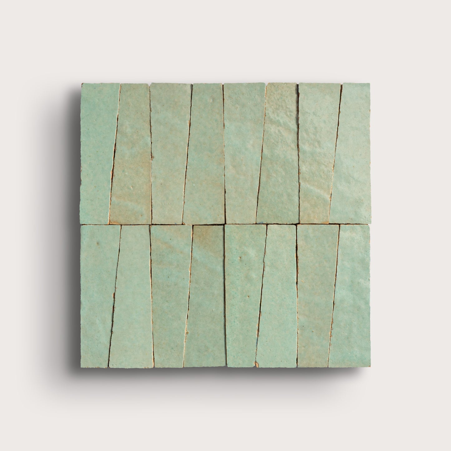 Rectangular green tile with a pattern of horizontal lines on a light gray background