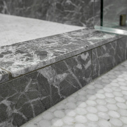 Gray marble shower step with a textured finish