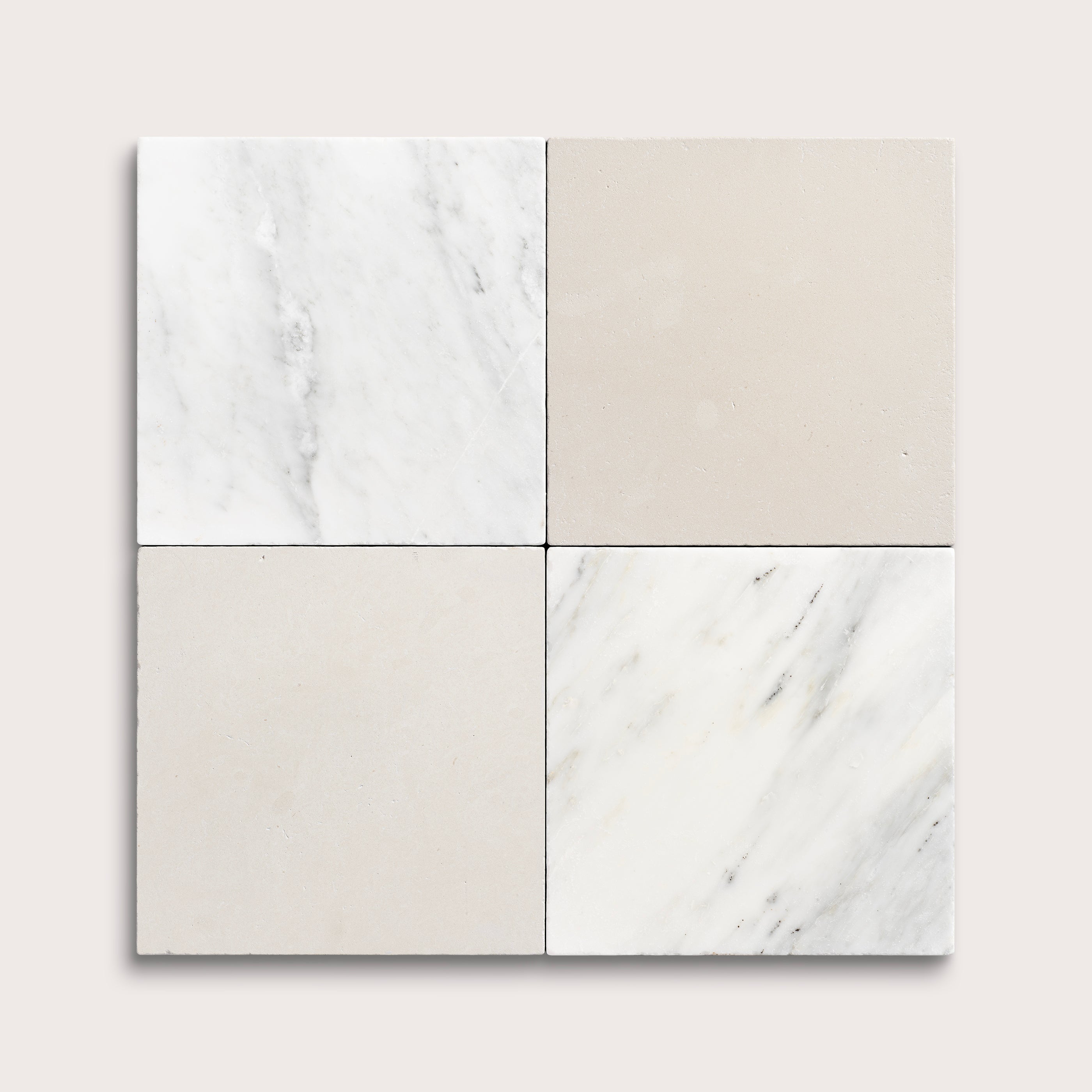 Four square tiles with marble-like patterns on a light gray background