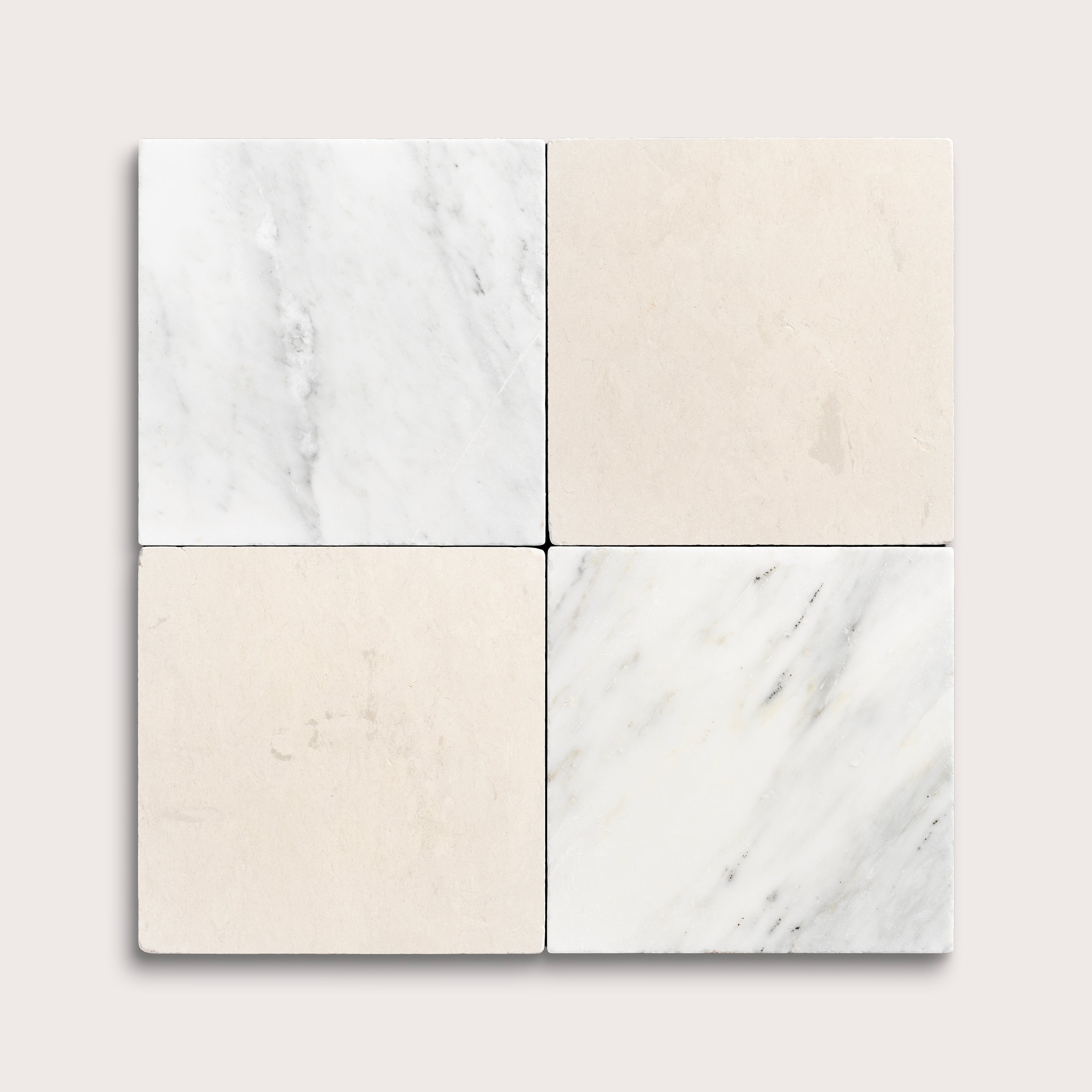 Four square tiles with marble patterns on a light gray background