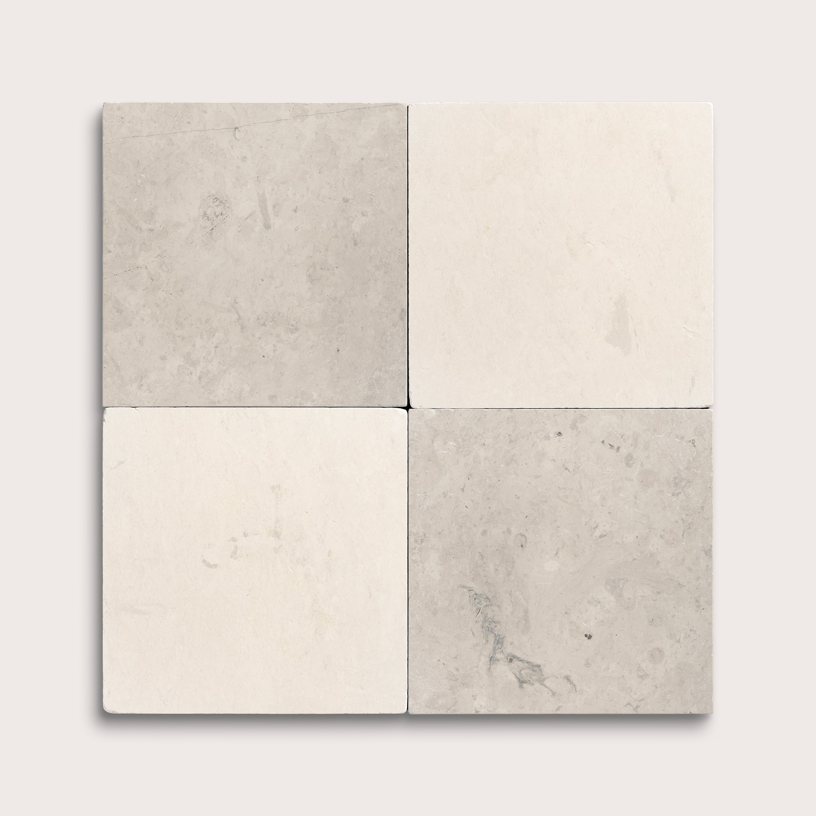 Four square tiles in gray and beige on a light gray background