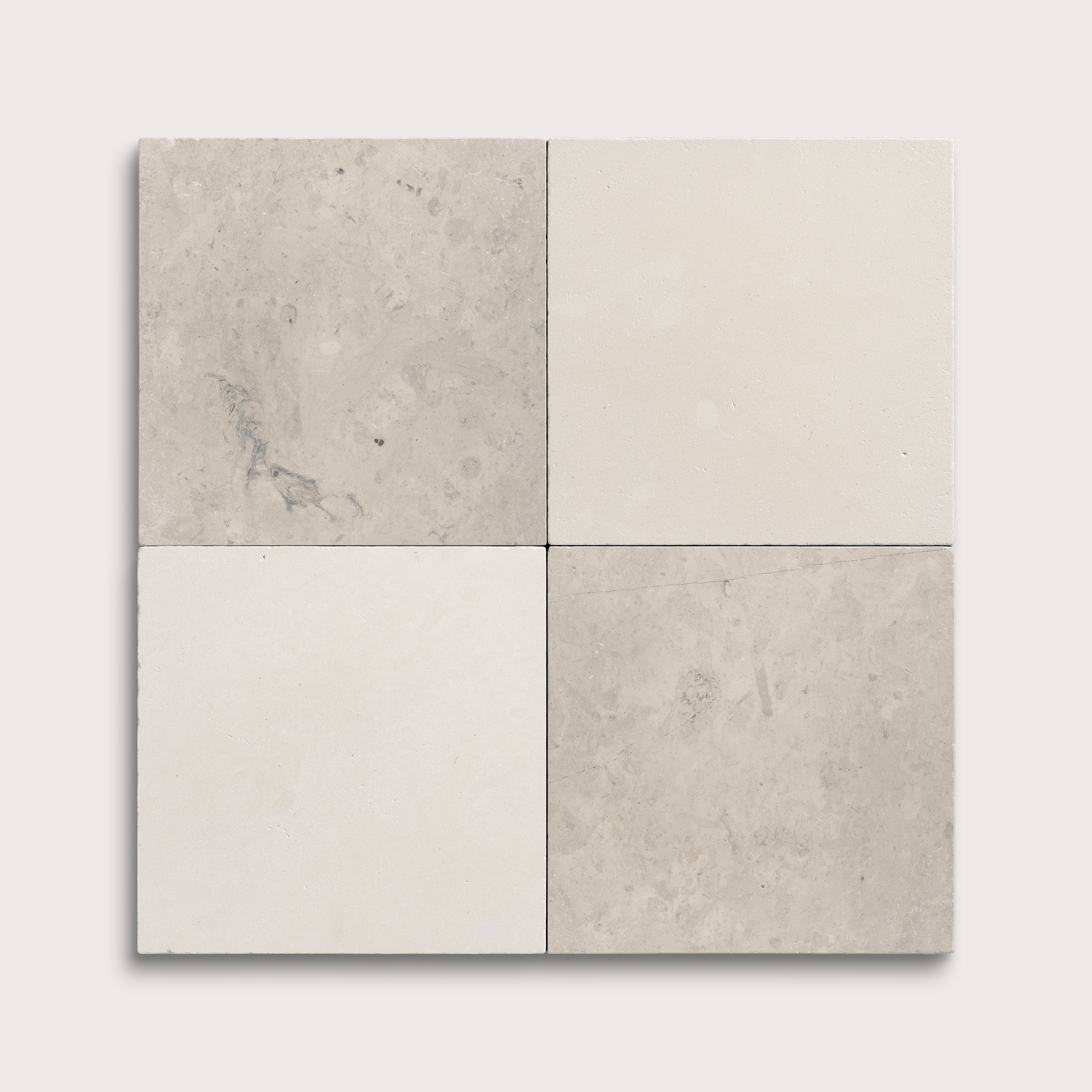 Four square tiles in gray and beige on a white background