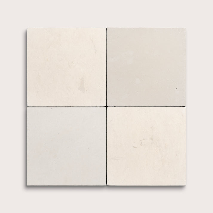 Four square tiles in beige and gray on a white background