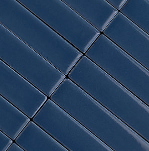 A close-up of glossy dark blue rectangular tiles arranged in a diagonal grid pattern.