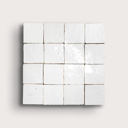Grid of small white zellige tiles on a light gray background