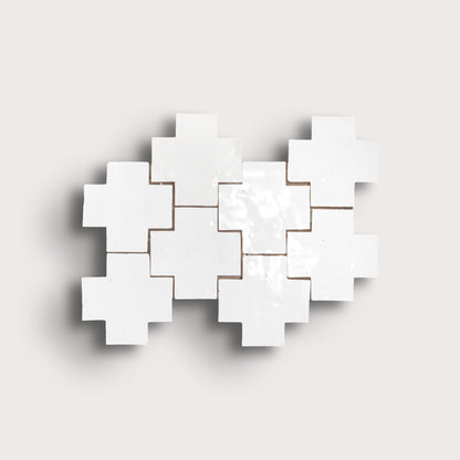 white zellige cross geometric design on a light gray background