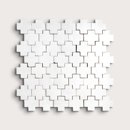 white zellige cross geometric design on a light gray background