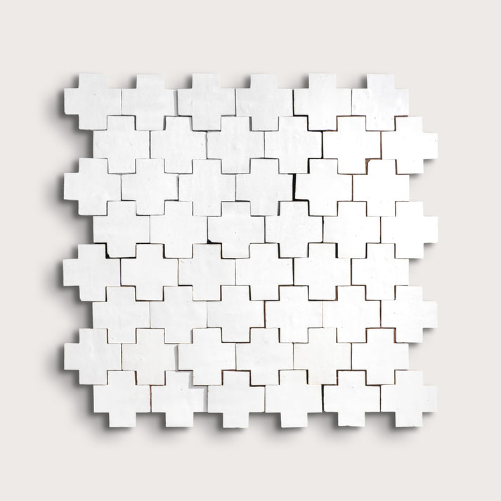 white zellige cross geometric design on a light gray background