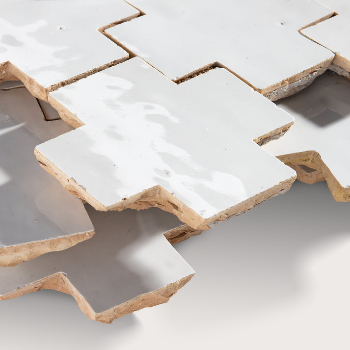 close up angle of white zellige tile in cross pattern