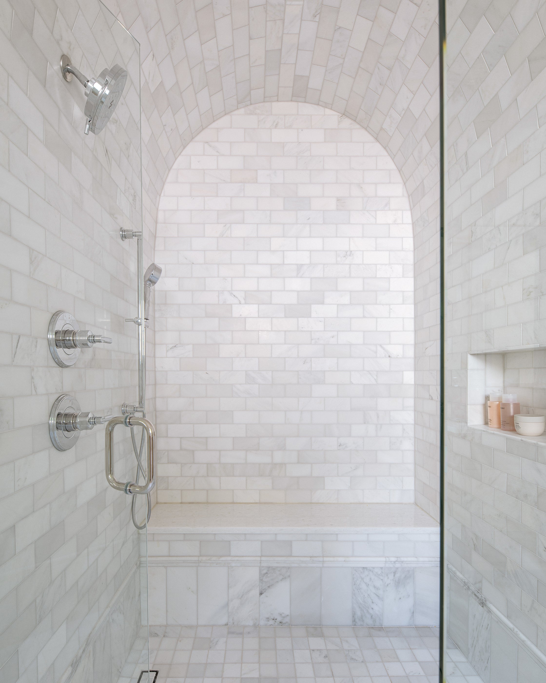 Modern shower with casablanca carrara marble tiles and chrome fixtures