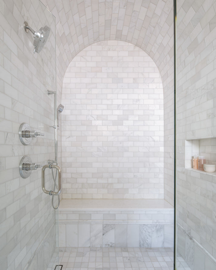 Modern shower with casablanca carrara marble tiles and chrome fixtures
