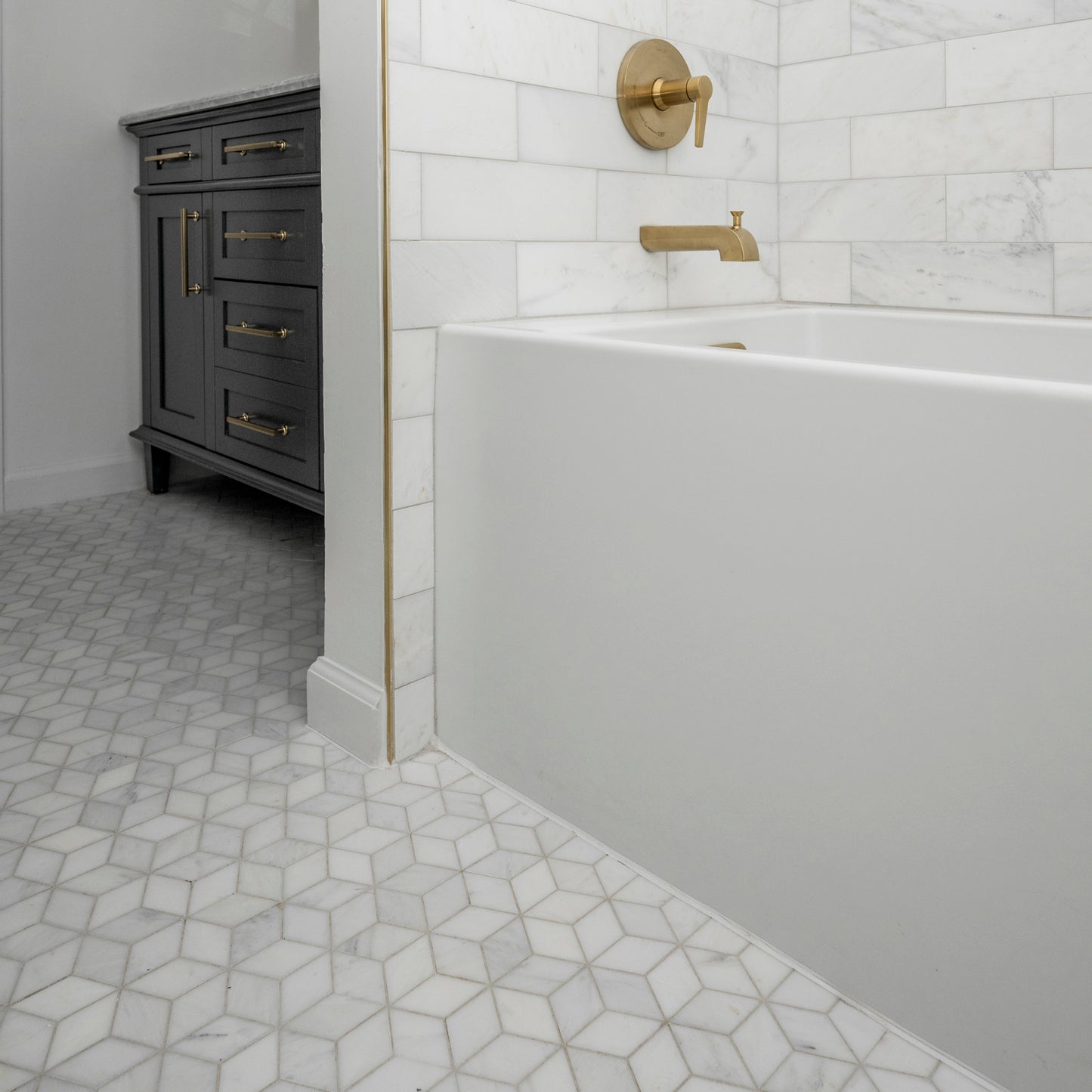 Bathroom with white bathtub, marble floor, and dark wooden cabinet.