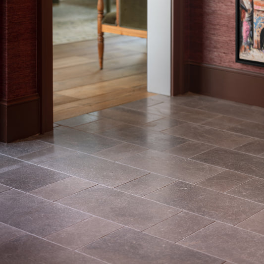 grey limestone rectangle tile installed on the floor in an entryway