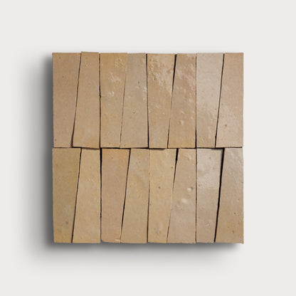 Beige stone tiles arranged in a geometric pattern on a white background