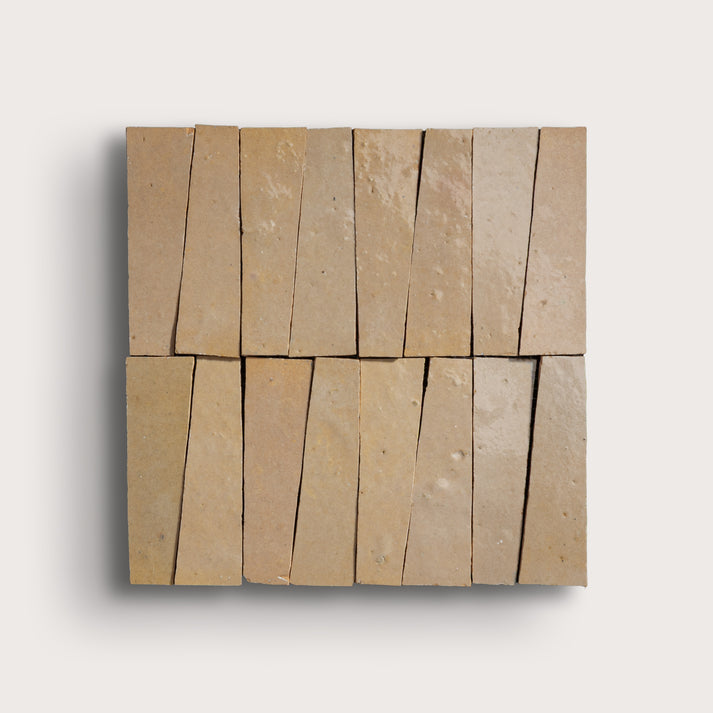 Beige stone tiles arranged in a geometric pattern on a white background