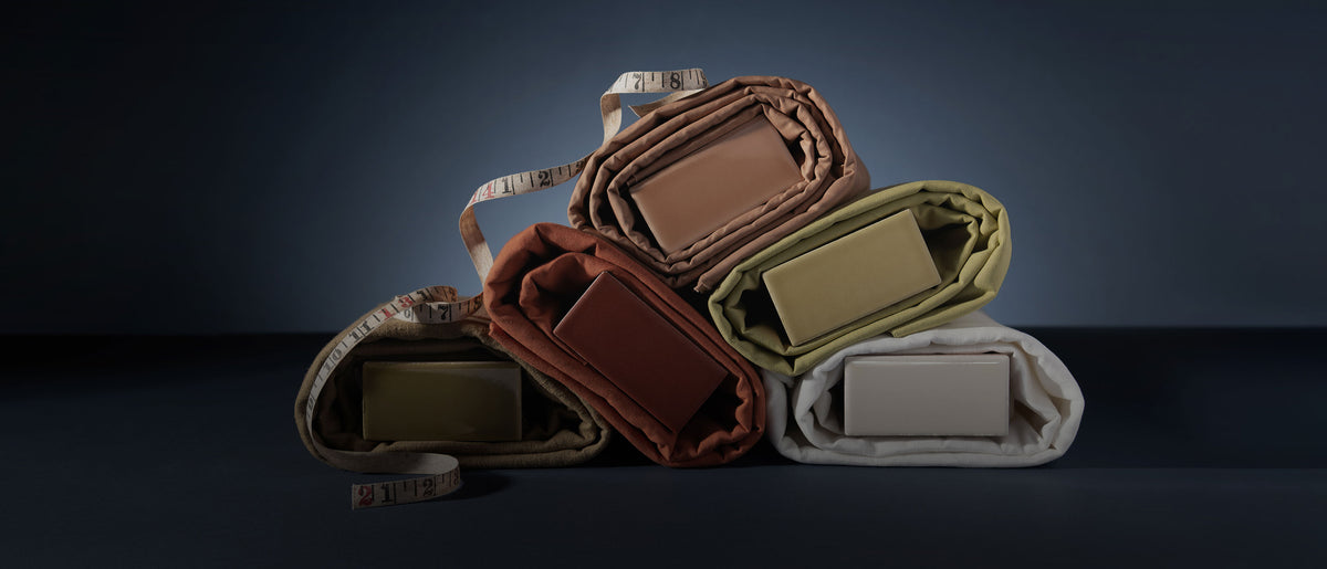 fall color palette of ceramic tile wrapped in fabric styled with a tape measure
