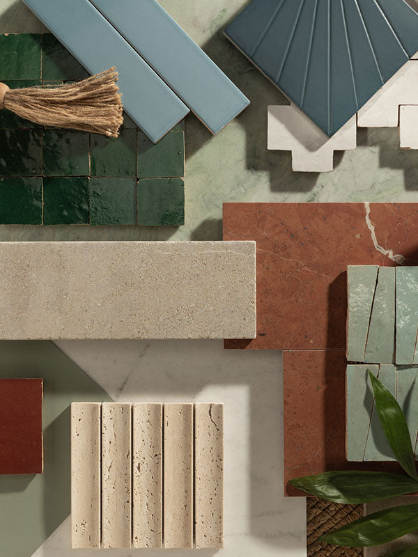Collection of various tiles in different colors and textures on a neutral background