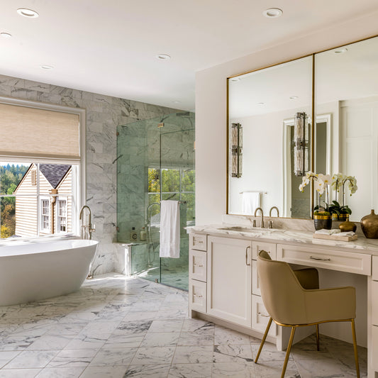 Luxurious bathroom with marble tiles, a freestanding bathtub, and a vanity area.