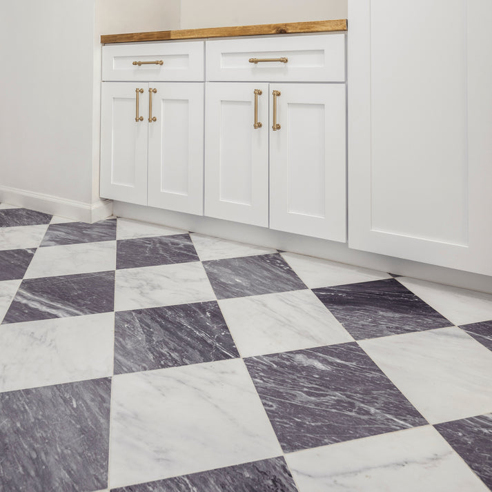 Kitchen with white cabinets and a checkered marble floor pattern