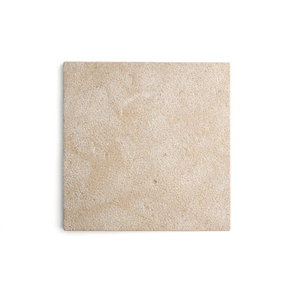 A square beige textured tile or stone sample with a fine granular surface, centered on a clean white background.