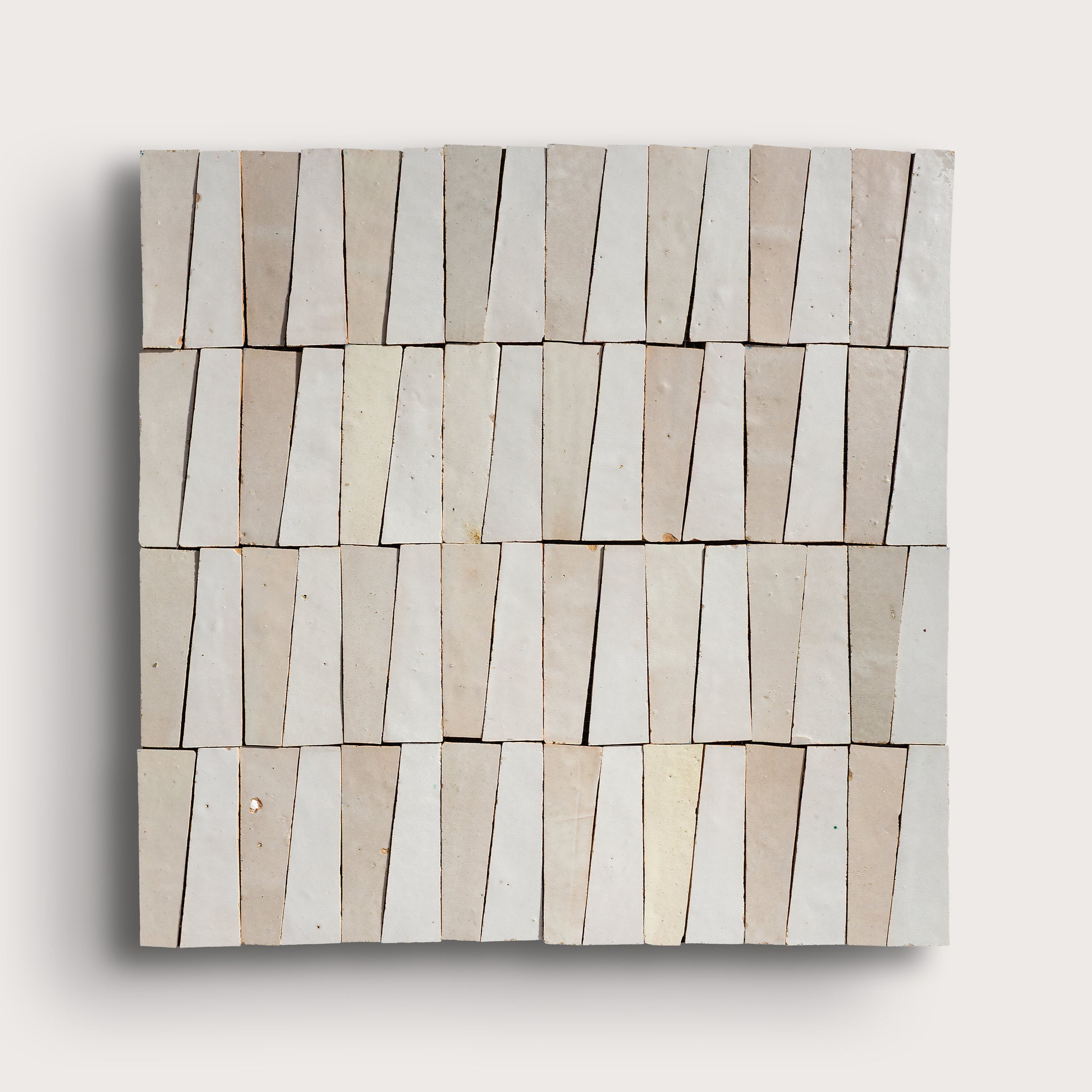 white trapezoid zellige tile on a light gray background